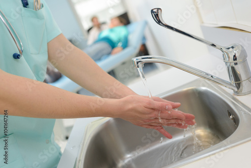 doctor washes hands before medical work photo