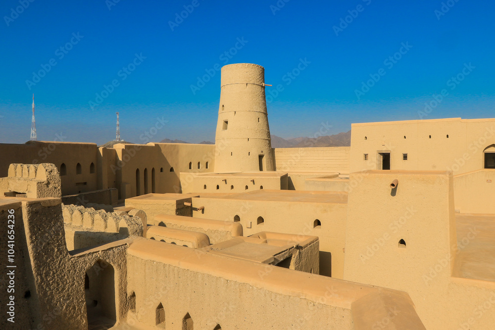Bahla Fort in Oman showcasing ancient architecture under a clear blue sky Bahla Fort in Oman showcasing ancient architecture under a clear blue sky