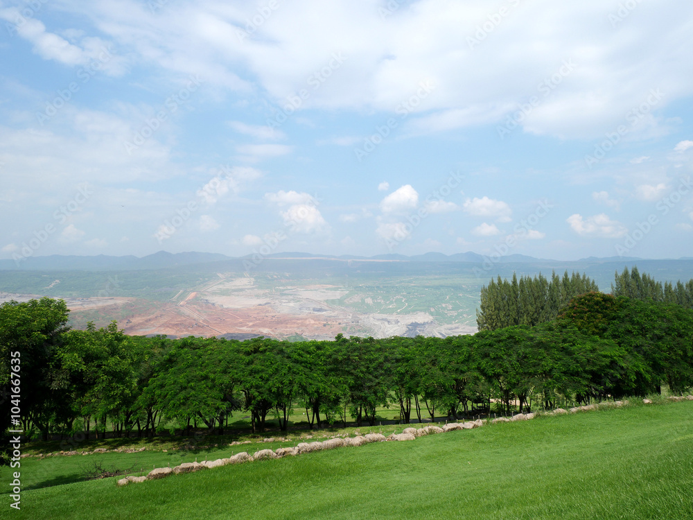 2024-10-01:Lampang Thailand: A park with green lawns and clear sky with a lignite mine in front. 2024-10-01:Lampang Thailand: A park with green lawns and clear sky with a lignite mine in front.