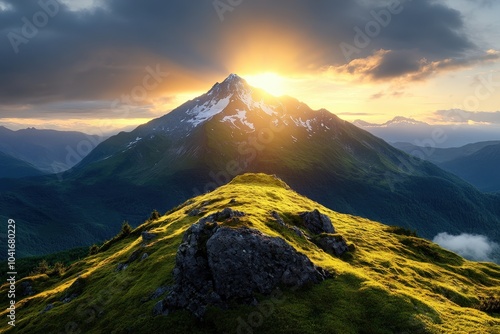 A stunning mountain peak bathed in the radiant glow of a setting sun, surrounded by lush green valleys, epitomizing the awe and grandeur of natural landscapes.