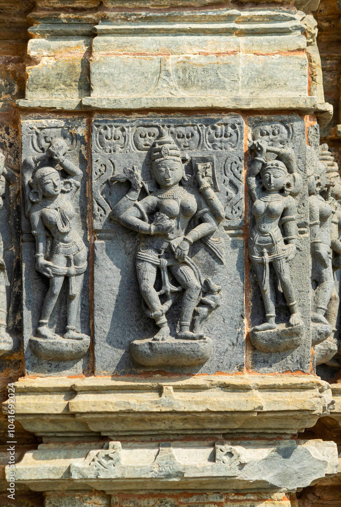 Carving of Jain goddess with maids at the Jain Temple, Arthuna Group of Temples, Banswara, Rajasthan, India. Carving of Jain goddess with maids at the Jain Temple, Arthuna Group of Temples, Banswara, Rajasthan, India.