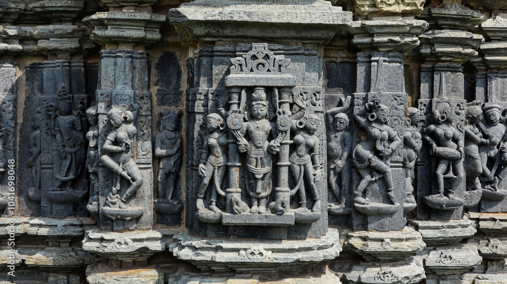 Carving of Lord Vishnu with musicians on Someshwara Mahadev Temple, Arthuna Group of Temples, Banswara, Rajasthan, India. Carving of Lord Vishnu with musicians on Someshwara Mahadev Temple, Arthuna Group of Temples, Banswara, Rajasthan, India.