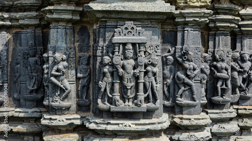 Carving of Lord Vishnu with musicians on Someshwara Mahadev Temple, Arthuna Group of Temples, Banswara, Rajasthan, India. photo