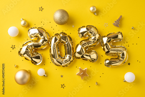 Golden 2025 balloons surrounded by festive decorations on a vibrant yellow background, celebrating the upcoming new year photo