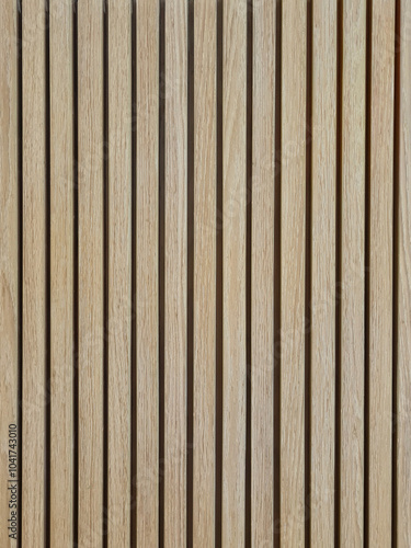 Background of oak acoustic wood wall panel. Vertical light brown natural wood textured wall. Vertical line wood panel texture pattern for decoration.