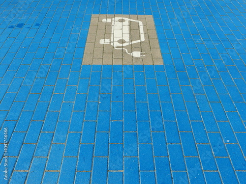 The eye-catching blue charging zone with the electric car symbol marks the path to an emission-free future. A symbol of modern urban planning and sustainable mobility photo