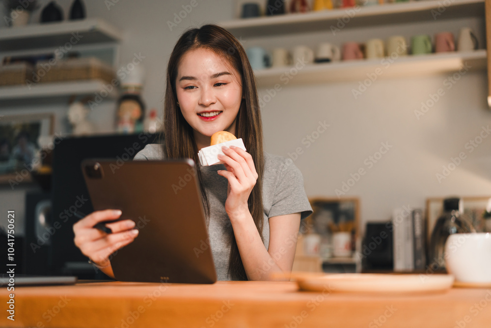 Enjoying snack while using tablet, young woman smiles in cozy indoor setting. warm atmosphere highlights her relaxed demeanor and engagement with device Enjoying snack while using tablet, young woman smiles in cozy indoor setting. warm atmosphere highlights her relaxed demeanor and engagement with device
