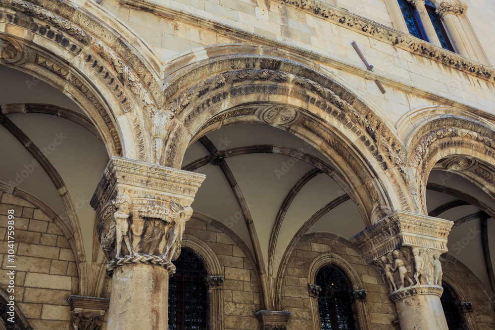 Fototapeta premium Exploring the majestic arches of Dubrovnik historic buildings during a sunny day in Croatia