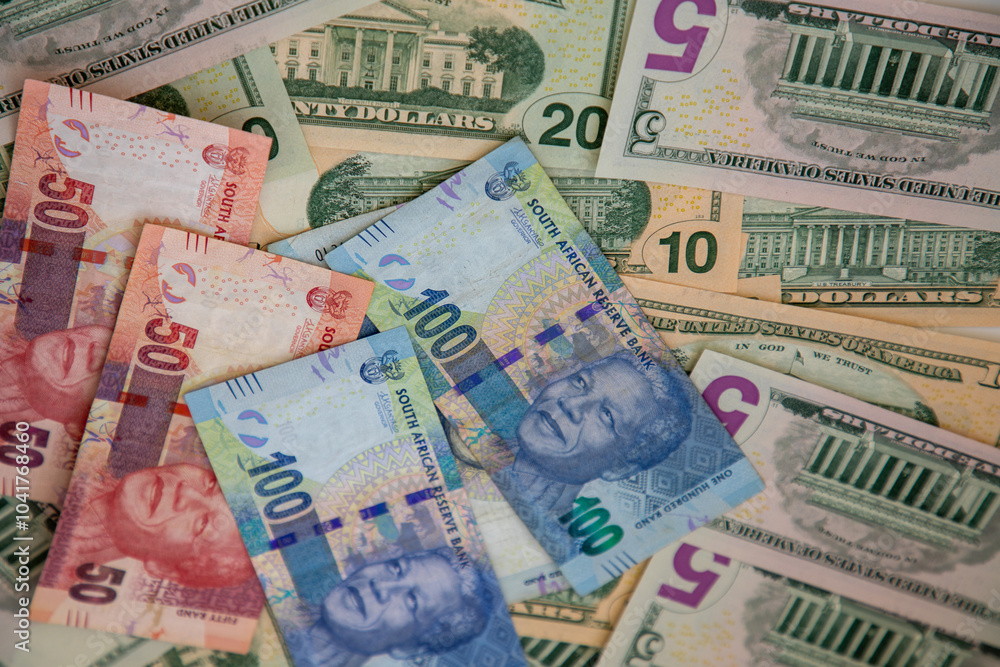 Selective focus on R50 and R100 South African currency notes with various denominations of US Dollar notes behind them. Selective focus on R50 and R100 South African currency notes with various denominations of US Dollar notes behind them.