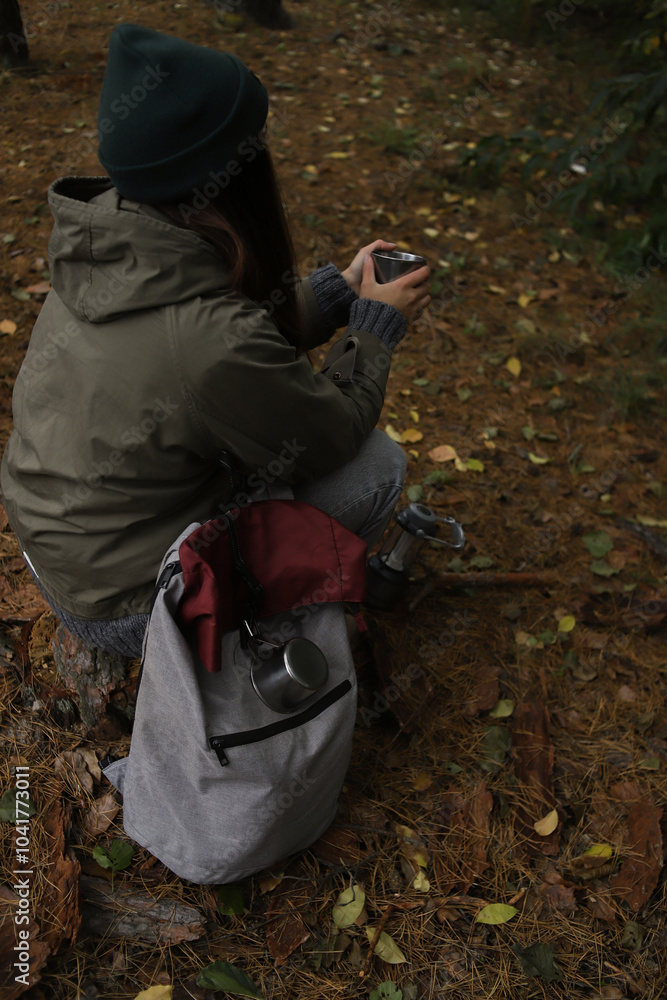 tourism. a tourist with a gray-burgundy backpack, mugs, a lantern with a compass travels through the wild forest tourism. a tourist with a gray-burgundy backpack, mugs, a lantern with a compass travels through the wild forest