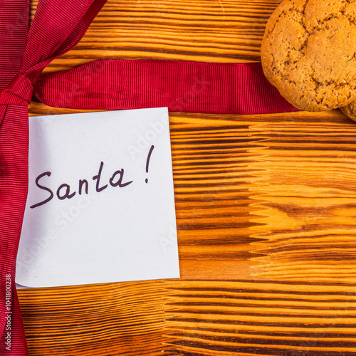 A note for Sanita with a red bow and cookies Christmas concept photo