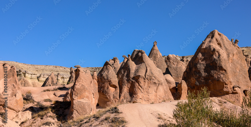 Remarkable rock formations in Cappadocia during bright daylight revealing natural beauty Remarkable rock formations in Cappadocia during bright daylight revealing natural beauty