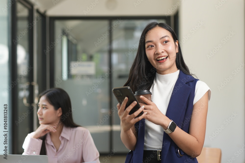 Happy Asian business people working together using laptop and tablet in office. Happy Asian business people working together using laptop and tablet in office.