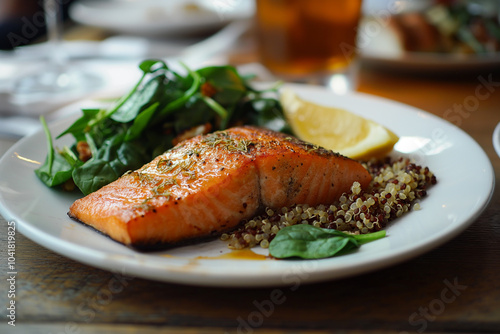 A plate of baked salmon with quinoa and spinach