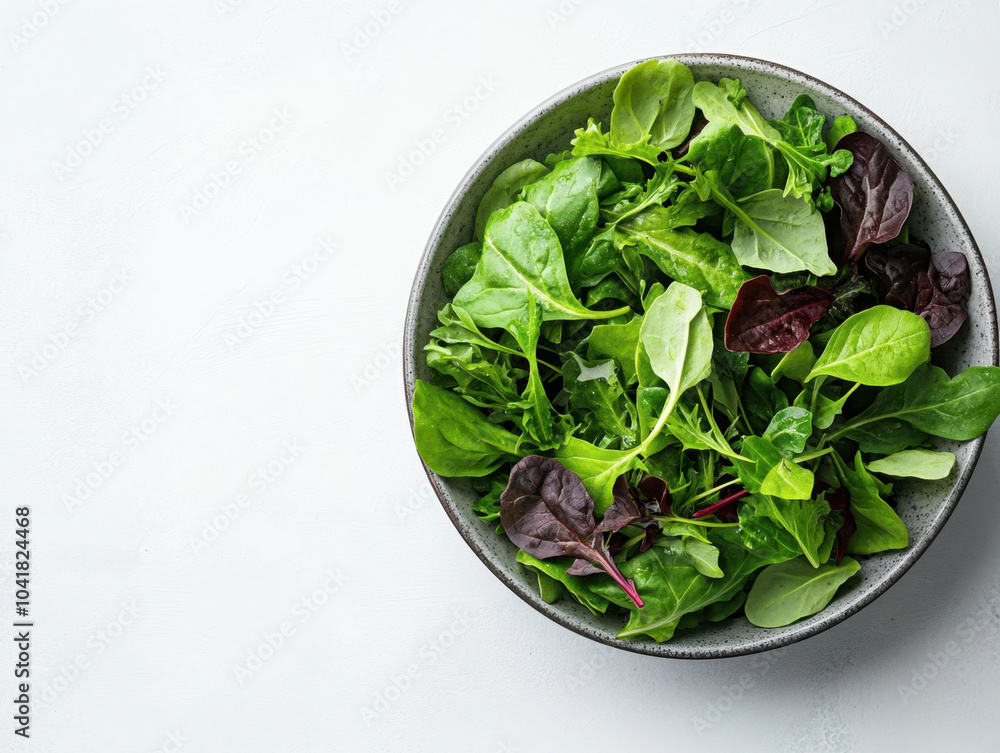 Fresh mixed greens in minimalist bowl create vibrant and healthy display, perfect for salads or garnishes. variety of textures and colors adds refreshing touch to any meal Fresh mixed greens in minimalist bowl create vibrant and healthy display, perfect for salads or garnishes. variety of textures and colors adds refreshing touch to any meal