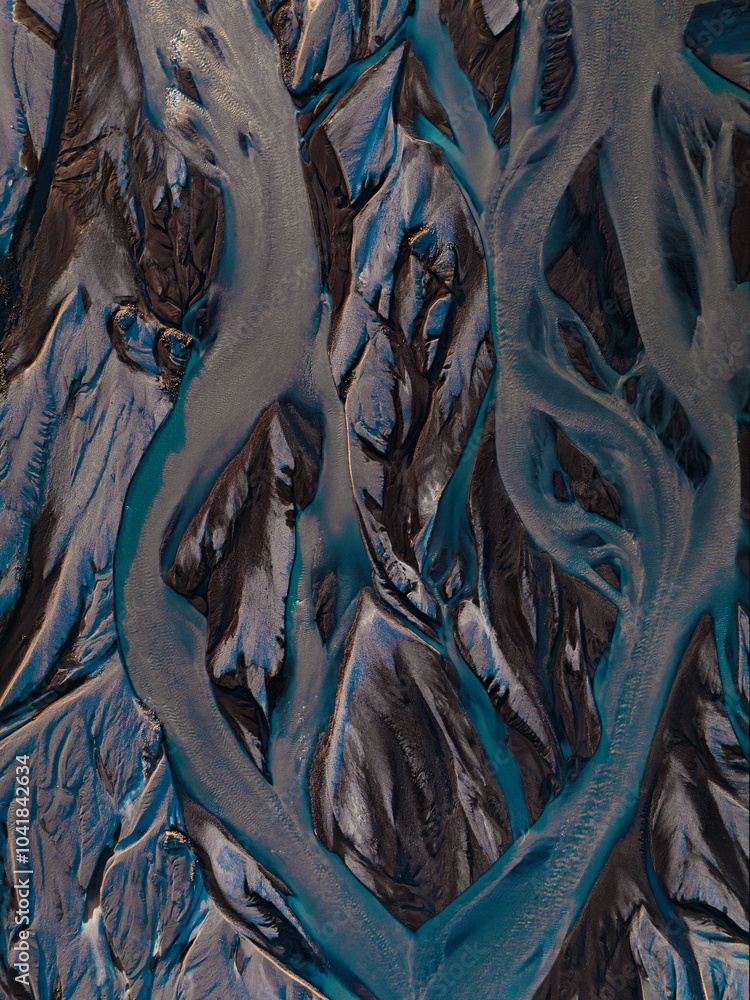 View from above, stunning patterns created in the volcanic sands of Iceland. As glaciers melt the water flows as rivers out to sea. Natural pattern, background, wallpaper.