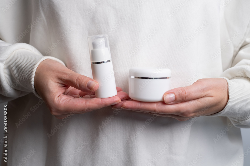 A jar of spa cream in the hands of a girl. Skin care. Medical and dermatological cosmetics for hands. Beauty and health of a woman. Spa treatments for the body. Container with natural cream close-up A jar of spa cream in the hands of a girl. Skin care. Medical and dermatological cosmetics for hands. Beauty and health of a woman. Spa treatments for the body. Container with natural cream close-up