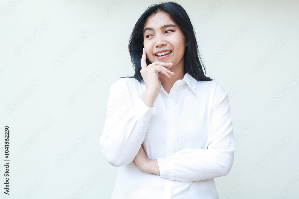 image of thoughtful asian business woman smiling look away to empty space with hands on chin and arms folded thinking idea wearing white formal suit shirt standing over isolated background image of thoughtful asian business woman smiling look away to empty space with hands on chin and arms folded thinking idea wearing white formal suit shirt standing over isolated background