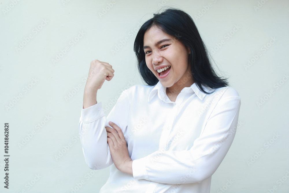 carefree proud asian business woman raising fist arms showing bicep muscle strength, showing victory win gesture, wearing white shirt formal suit isolated in white background carefree proud asian business woman raising fist arms showing bicep muscle strength, showing victory win gesture, wearing white shirt formal suit isolated in white background