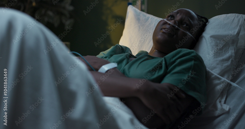 Young woman lying in hospital room, curled up in pain clutching her stomach, crying. Young woman lying in hospital room, curled up in pain clutching her stomach, crying.