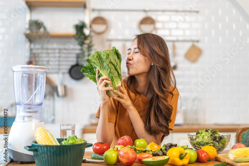 Portrait of beauty body slim healthy asian woman eating vegan food healthy with fresh vegetable salad in kitchen at home.diet, vegetarian, fruit, wellness, health, green food.Fitness and healthy food