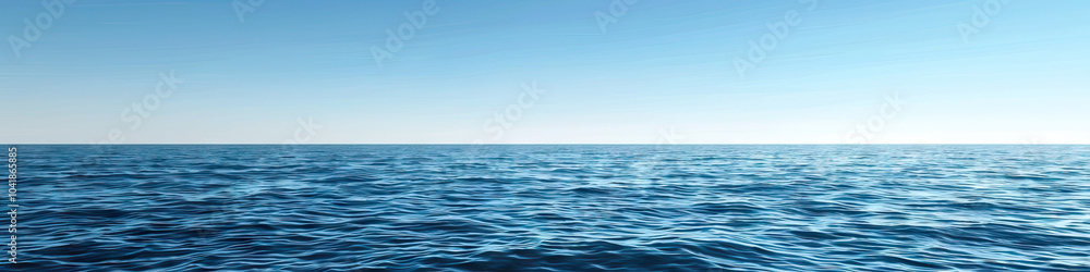 Obraz premium A calm blue sea, its surface dotted with small whitecaps under a clear sky.