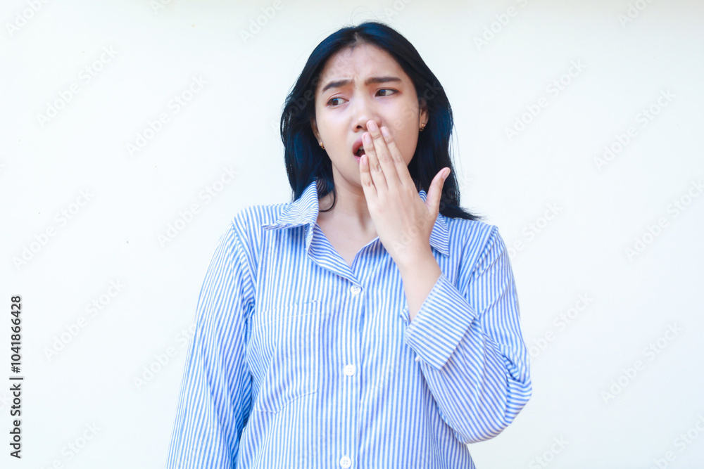 shocked asian woman covering her mouth wide open wearing striped shirt isolated on white background shocked asian woman covering her mouth wide open wearing striped shirt isolated on white background