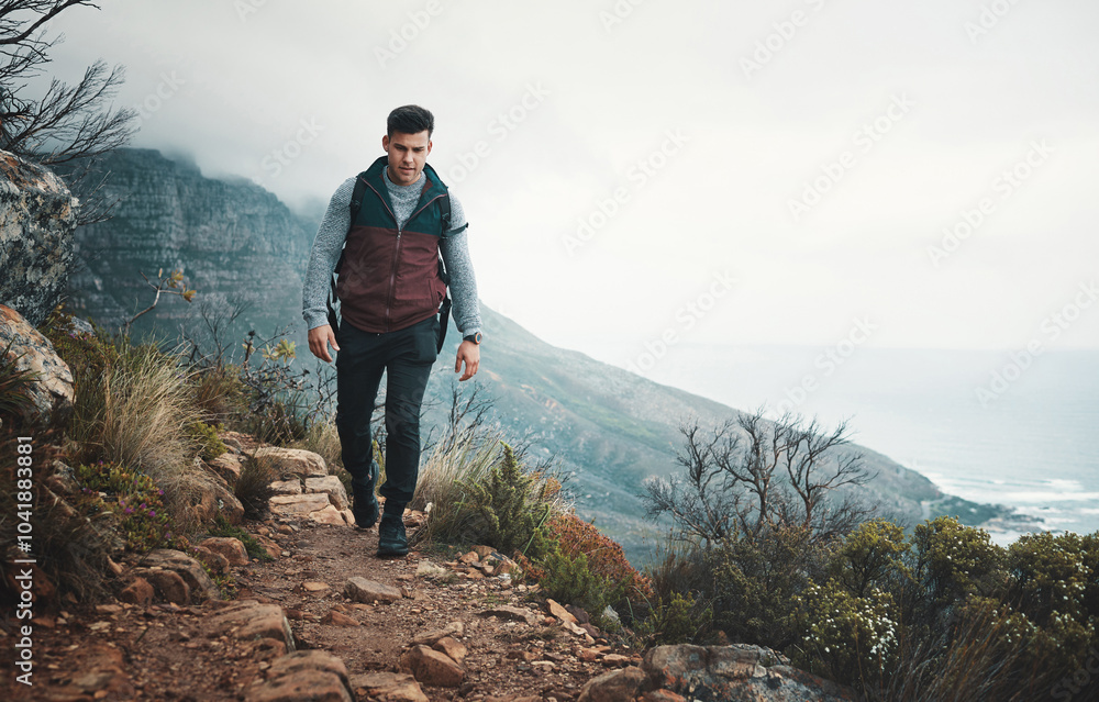 Obraz premium Hiking, trail and travel with man on mountain for explore, walking and adventure. Challenge, wellness and holiday with person and trekking in nature path for backpacking, fitness and vacation