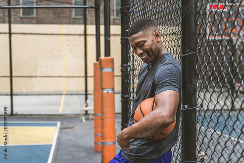 Black sportive basketball player playing basketball on a court in New York City