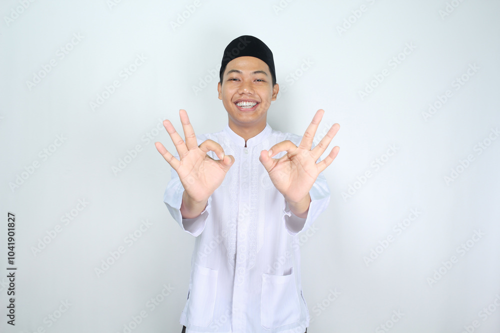 smiling asian man muslim show ok signs isolated on white background smiling asian man muslim show ok signs isolated on white background