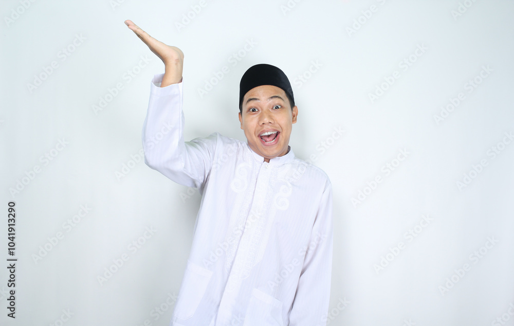 funny asian muslim man with surprised expression raising hand to presenting isolated on white background funny asian muslim man with surprised expression raising hand to presenting isolated on white background