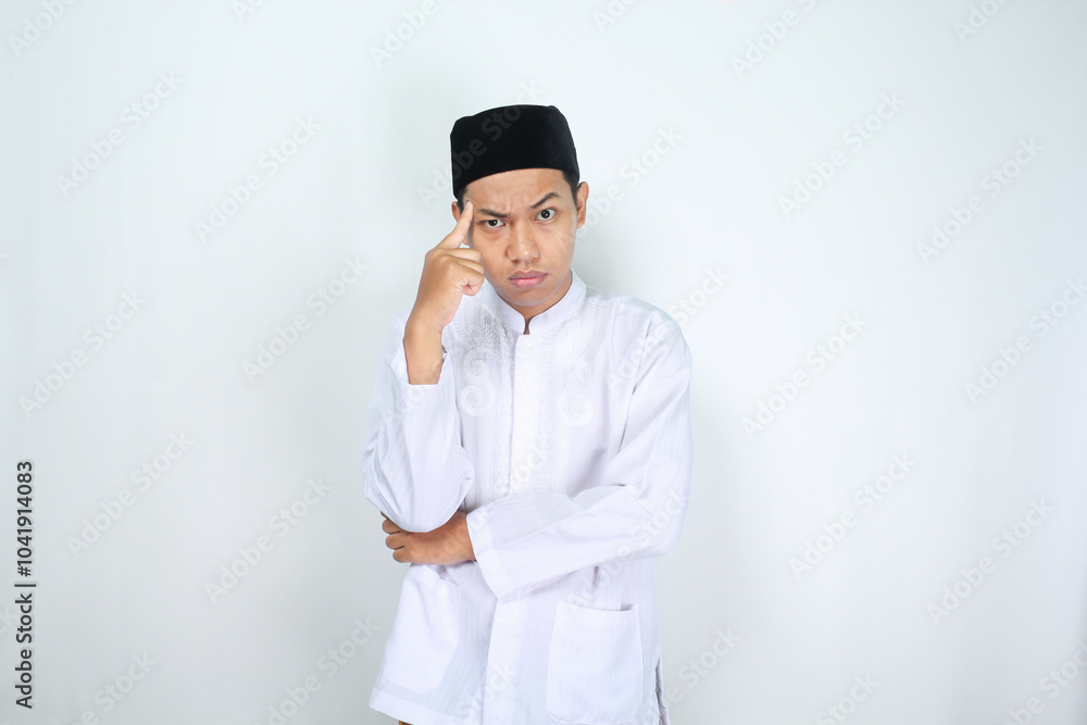 thoughtful muslim asian man touching his head with finger isolated on white background thoughtful muslim asian man touching his head with finger isolated on white background