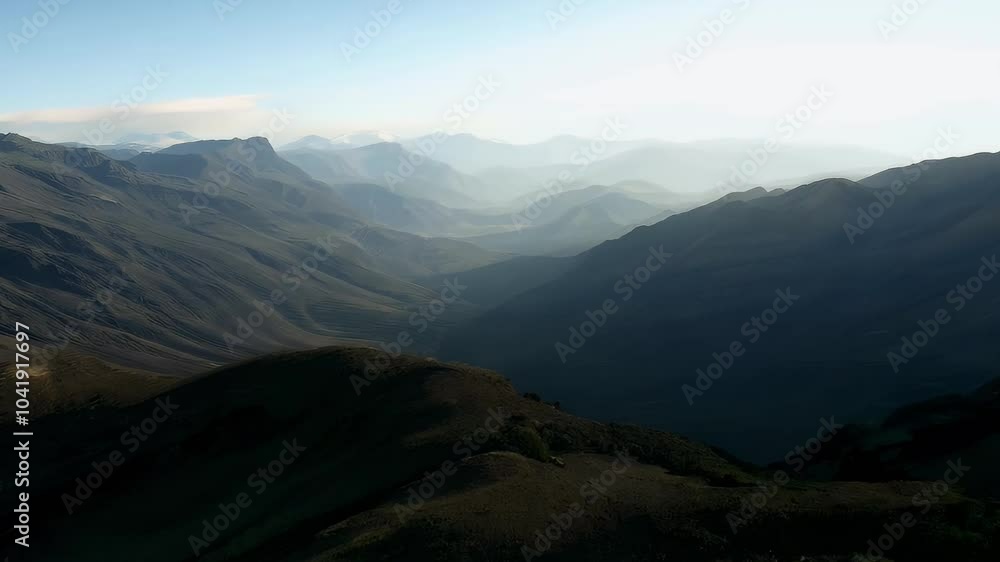 A serene mountain landscape with layered hills and distant peaks under a clear sky. A serene mountain landscape with layered hills and distant peaks under a clear sky.
