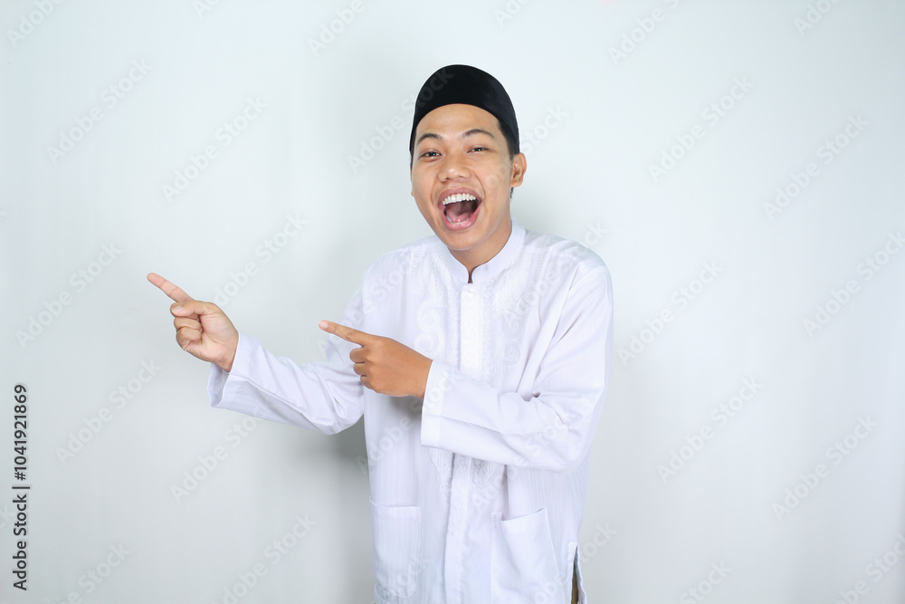 attractive muslim asian man pointing to the right side and shouting with mouth open isolated on white background attractive muslim asian man pointing to the right side and shouting with mouth open isolated on white background