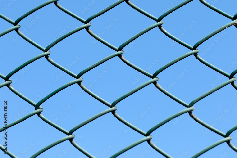 Diamond weave pattern of rusty chain link fence