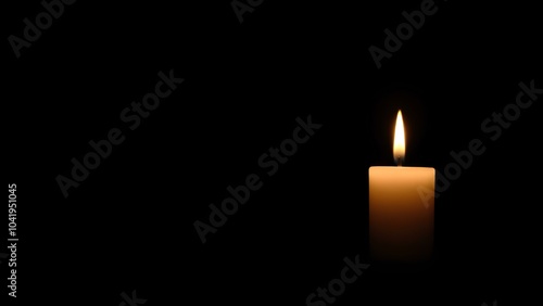 Burning candle on black background with space for text. For themes related to remembrance, mourning, loss or spirituality, hope and keeping the fire of life burning.