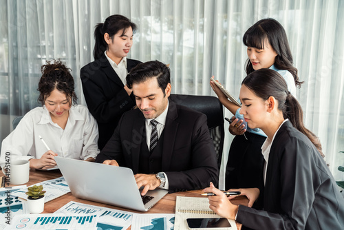 Diverse group of business analyst team analyzing financial data report paper on office table. Chart and graph dashboard by business intelligence analysis for strategic marketing planning Meticulous