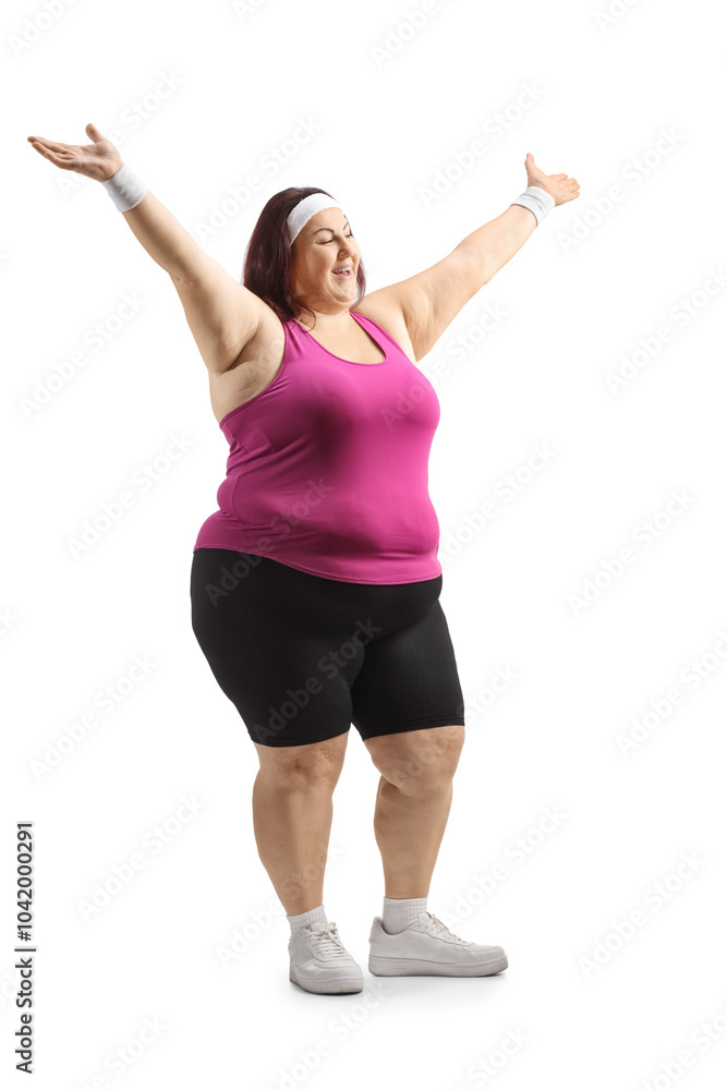 Overweight young woman in sportswear raising arms Overweight young woman in sportswear raising arms