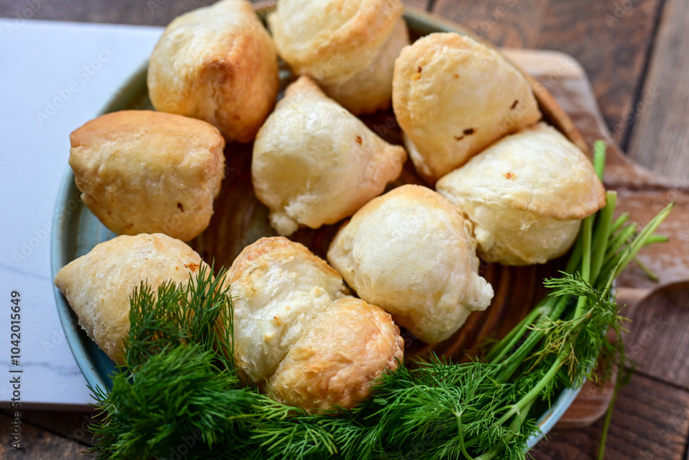 Fresh baked home made Mini cheese puff pastries.Cheese pie with phyllo pastry and herbs Fresh baked home made Mini cheese puff pastries.Cheese pie with phyllo pastry and herbs