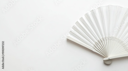 Flat lay of a traditional white folding fan, isolated on a clean white background with space for design.