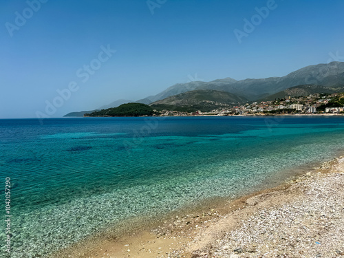 Panoramic view of the picturesque coastline of coastal tourist town Himare, Vlore, Albania. Sand beach Potami with scenic vistas of majestic mountains of Karaburun-Sazan Marine Park. Summer vacation photo