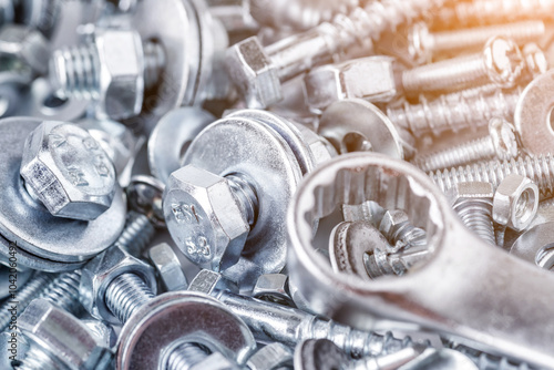 Composition with a variety of metal tools.Sockets, tools,spanners and bits.Wrenches on nuts and bolts. Industrial background.Close-up of various screws. Use for background, photo