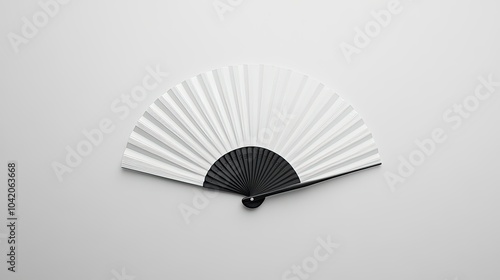 Minimalistic display of a classic white folding hand fan, laid flat against a seamless white background.