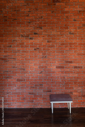 One old vintage chair in the interior of a room with a brick wall