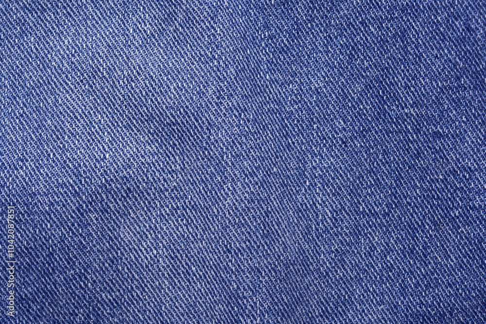 Close-up texture of blue denim fabric with detailed weave pattern in high resolution for fashion and design inspiration. Close-up texture of blue denim fabric with detailed weave pattern in high resolution for fashion and design inspiration.