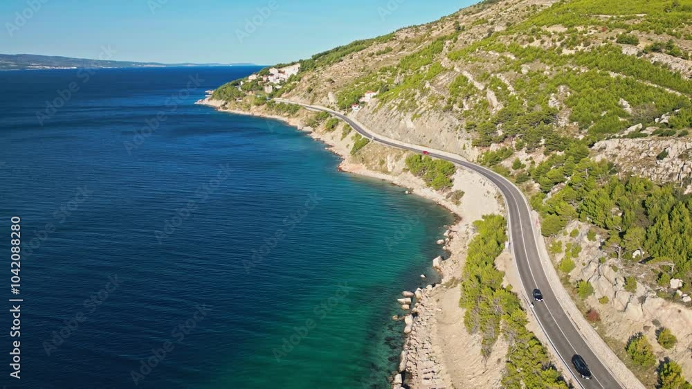 Winding road between the sea and the mountains at sunny morning time on the Adriatic coast near Omis, Dalmatia, Croatia Winding road between the sea and the mountains at sunny morning time on the Adriatic coast near Omis, Dalmatia, Croatia