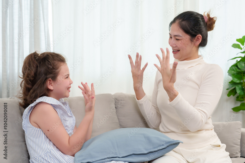 Mother and daughter smiling and showing off their freshly painted nails during a fun, light-hearted bonding moment at home. The scene reflects happiness, creativity, and love shared between them. Mother and daughter smiling and showing off their freshly painted nails during a fun, light-hearted bonding moment at home. The scene reflects happiness, creativity, and love shared between them.