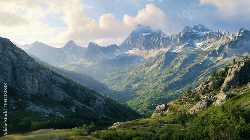 Majestic mountain range with snow-capped peaks and green valleys.