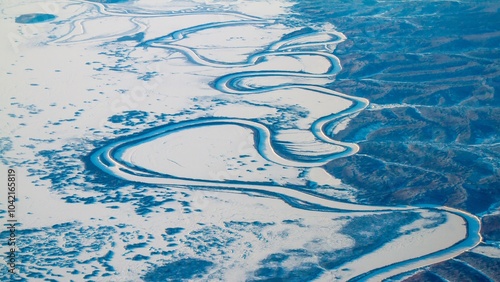 An aerial view of a  winding river on a cold winter morning near Nome, Alaska.
