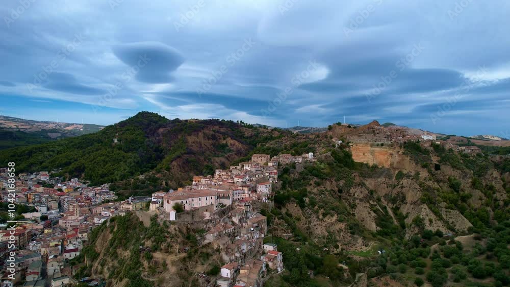 4K Aerial drone video of ancient town elevated in the hills with unreal cloud shapes with a mystical look. Abandoned ghost town Tursi in Italy outback with empty houses and streets 4K Aerial drone video of ancient town elevated in the hills with unreal cloud shapes with a mystical look. Abandoned ghost town Tursi in Italy outback with empty houses and streets